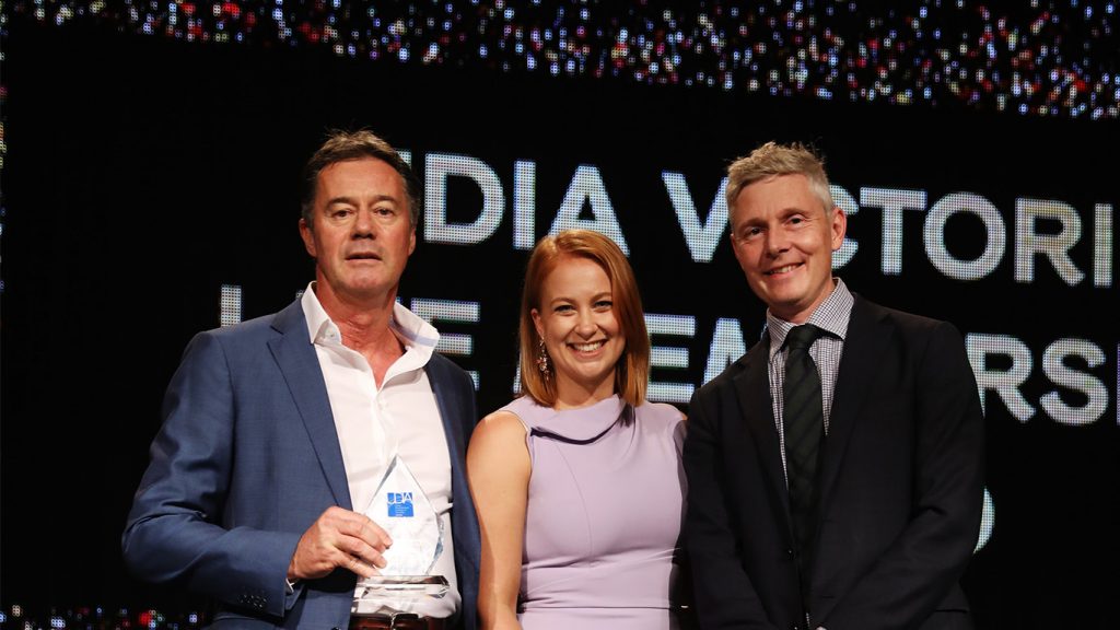 Tony Johnson is presented the Lifetime Achievement Award by UDIA's CEO, Danni Addison, and President, Jason Shaw